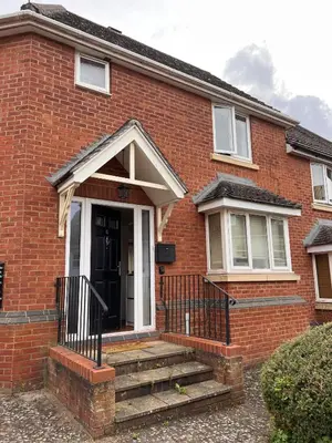 a brick house with stairs leading to the front door at La CAZA Guest House in Royston