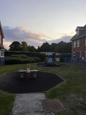 a picnic table in a yard with a playground at La CAZA Guest House in Royston