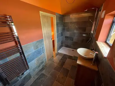 a bathroom with a tub and a sink and a shower at Okovango Cabin in Holton
