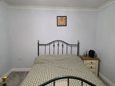 a bedroom with a bed and a picture on the wall at Stay Near Colchester twn centre2 in Colchester