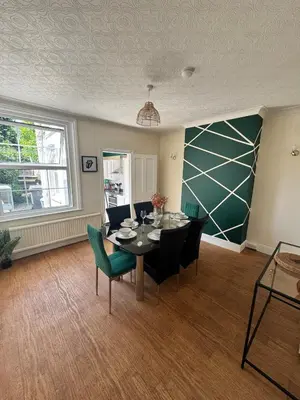 a dining room with a table and chairs at Contractors, Long stay,WI-Fl, Garden, parking in Chelmsford