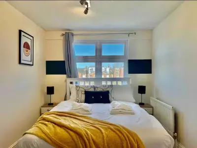 a bedroom with a large bed with a window at Contractors, Long stay,WI-Fl, Garden, parking in Chelmsford