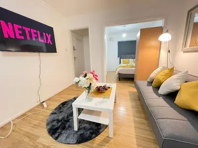 a living room with a couch and a table at Cosy Studio in Stevenage