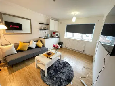 a living room with a couch and a table at Cosy Studio in Stevenage
