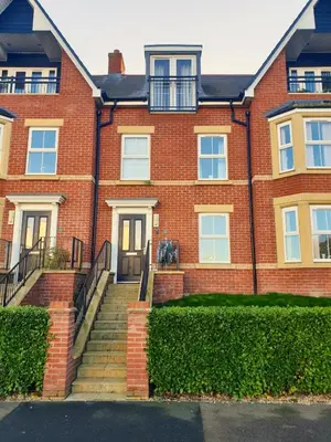 a brick house with stairs in front of it at Martello Sunrise - Luxury 3-bedroom Seaview Beach House in Felixstowe