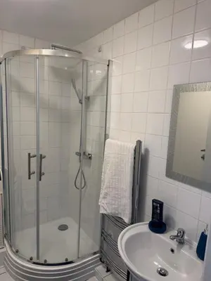 a bathroom with a shower and a sink at Fully en-suite with kitchen