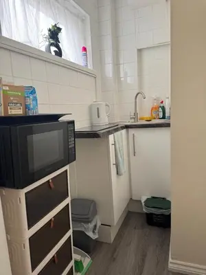 a small kitchen with a tv on a cabinet at Fully en-suite with kitchen