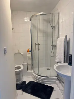 a bathroom with a shower and a toilet and a sink at Fully en-suite with kitchen