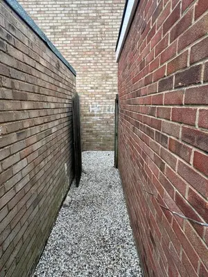 a brick wall next to a brick building at Fully en-suite with kitchen