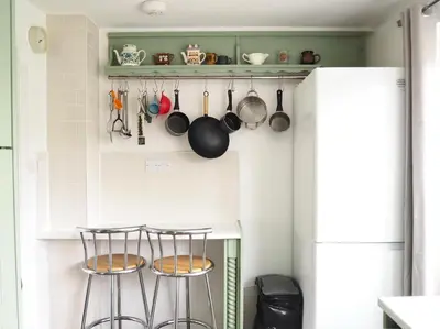 a kitchen with two stools and pots and pans at Cosy Room in Debenham in Debenham