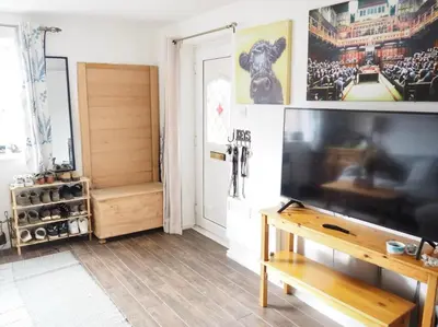 a living room with a large flat screen tv at Cosy Room in Debenham in Debenham