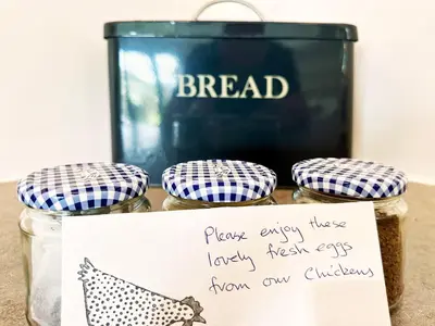 a sign on a table with three jars of food at The Barn at Orford Lodge by The Suffolk Cottage Collection in Orford