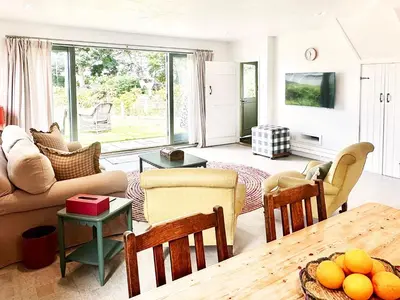 a living room with a couch and a table at The Barn at Orford Lodge by The Suffolk Cottage Collection in Orford
