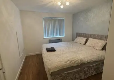a bedroom with a bed and a window at Hamilton Court in Great Burstead