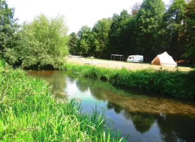 a view of a river with a tent and a field at Farm stay belltent activities in Bramfield