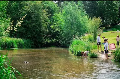 a group of people are standing in a river at Farm stay belltent activities in Bramfield