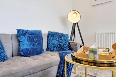 a living room with a couch and a table at Cozy 1 Bed Flat Corringham-Essex in Fobbing