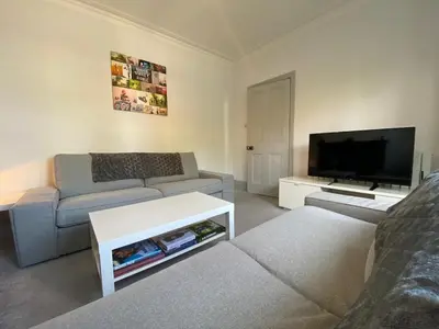 a living room with a couch and a flat screen tv at Three Bedroom Home Close to central Cambridge in Chesterton