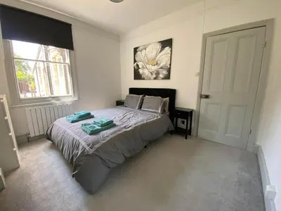 a bedroom with a bed with two towels on it at Three Bedroom Home Close to central Cambridge in Chesterton