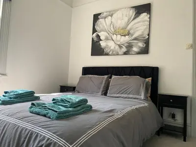 a bedroom with a bed with towels on it at Three Bedroom Home Close to central Cambridge in Chesterton