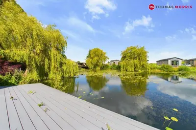 a view of a river with trees and houses at Lakeside Lodge Retreat with Views in Fenstanton