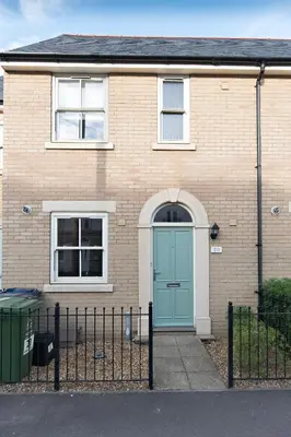 a house with a blue door and a fence at Camstay Abbey Street in Cambridge