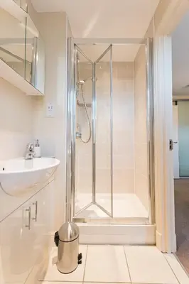 a bathroom with a shower and a sink at Camstay Abbey Street in Cambridge