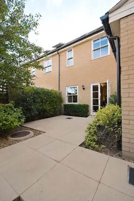 an empty sidewalk in front of a building at Camstay Abbey Street in Cambridge