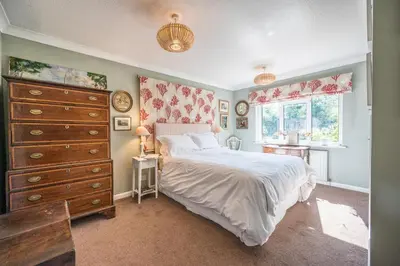 a bedroom with a large bed and a dresser at NO 108, private room in Aldeburgh in Aldeburgh
