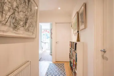 a hallway with a book shelf with books at NO 108, private room in Aldeburgh in Aldeburgh