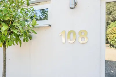 a white house with a house number on it at NO 108, private room in Aldeburgh in Aldeburgh