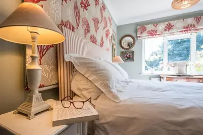 a bedroom with a bed with a lamp and glasses at NO 108, private room in Aldeburgh in Aldeburgh