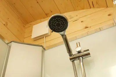 a spatula hanging from a ceiling in a bathroom at Highgate Cabin in Takeley