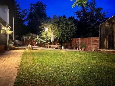 a garden at night with a table and a fence at Lucas farm barn
