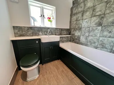 a bathroom with a toilet and a sink and a tub at Lucas farm barn