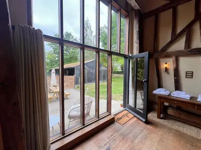 a room with a sliding glass door to a patio at Lucas farm barn