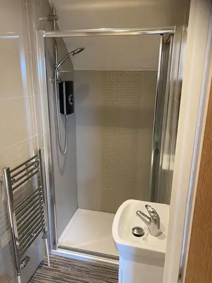 a bathroom with a shower and a sink at Cosy Loft Retreat off Vibrant Mill Road just minutes from station in Cambridge