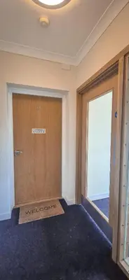 a room with a door with a welcome sign on it at The Cambridge Penthouse in Cambridge