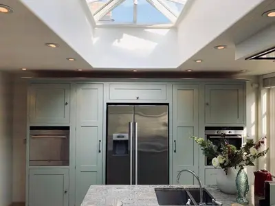 a kitchen with a stainless steel refrigerator and a skylight at Stunning Central Georgian Home in Cambridge