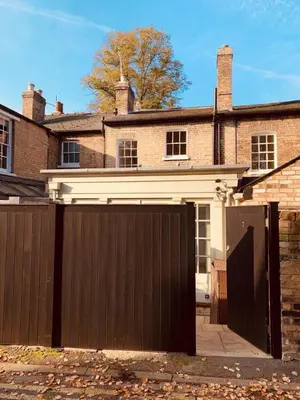 a garage in front of a brick house at Stunning Central Georgian Home in Cambridge