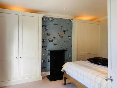 a bedroom with a bed and a wall with fishes at Stunning Central Georgian Home in Cambridge