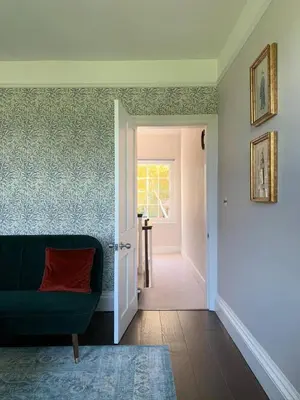 a living room with a green couch and a door at Stunning Central Georgian Home in Cambridge