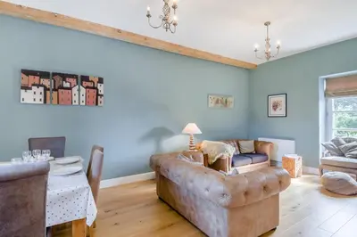 a living room with a couch and a table at 3 Bed in Blythburgh oc-h32647 in Blyford