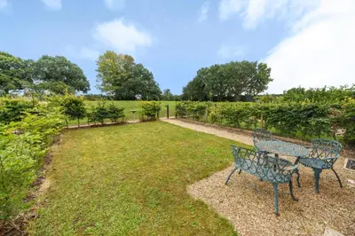 a park with two benches in the grass at 3 Bed in Blythburgh oc-h32647 in Blyford