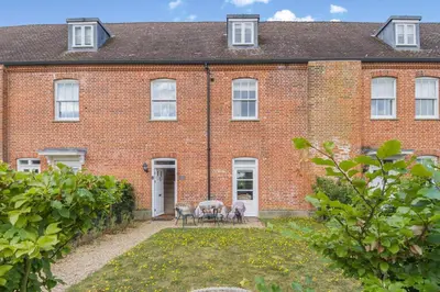 a brick house with a table and chairs in front of it at 3 Bed in Blythburgh oc-h32647 in Blyford