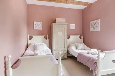 two twin beds in a room with pink walls at 3 Bed in Blythburgh oc-h32647 in Blyford