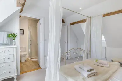 a white bedroom with a bed with towels on it at 3 Bed in Blythburgh oc-h32647 in Blyford