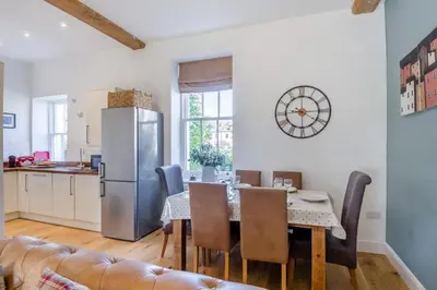 a kitchen and dining room with a table and a refrigerator at 3 Bed in Blythburgh oc-h32647 in Blyford