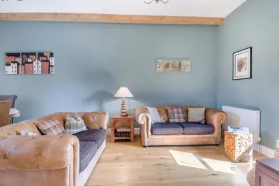 a living room with two couches and a table at 3 Bed in Blythburgh oc-h32647 in Blyford