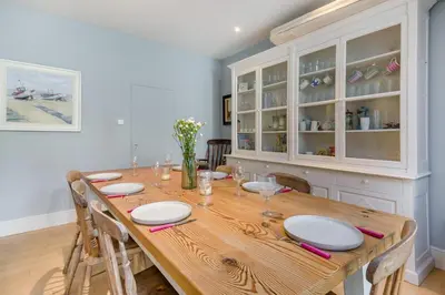 a dining room with a wooden table and chairs at 3 Bed in Aldeburgh oc-f32700 in Aldeburgh